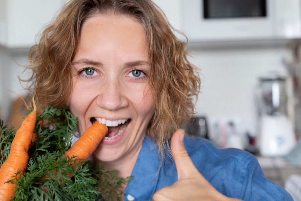 carrots grown on an eco product farm organic orange carrot raw healthy vitamins eating woman t20 eA3mPB