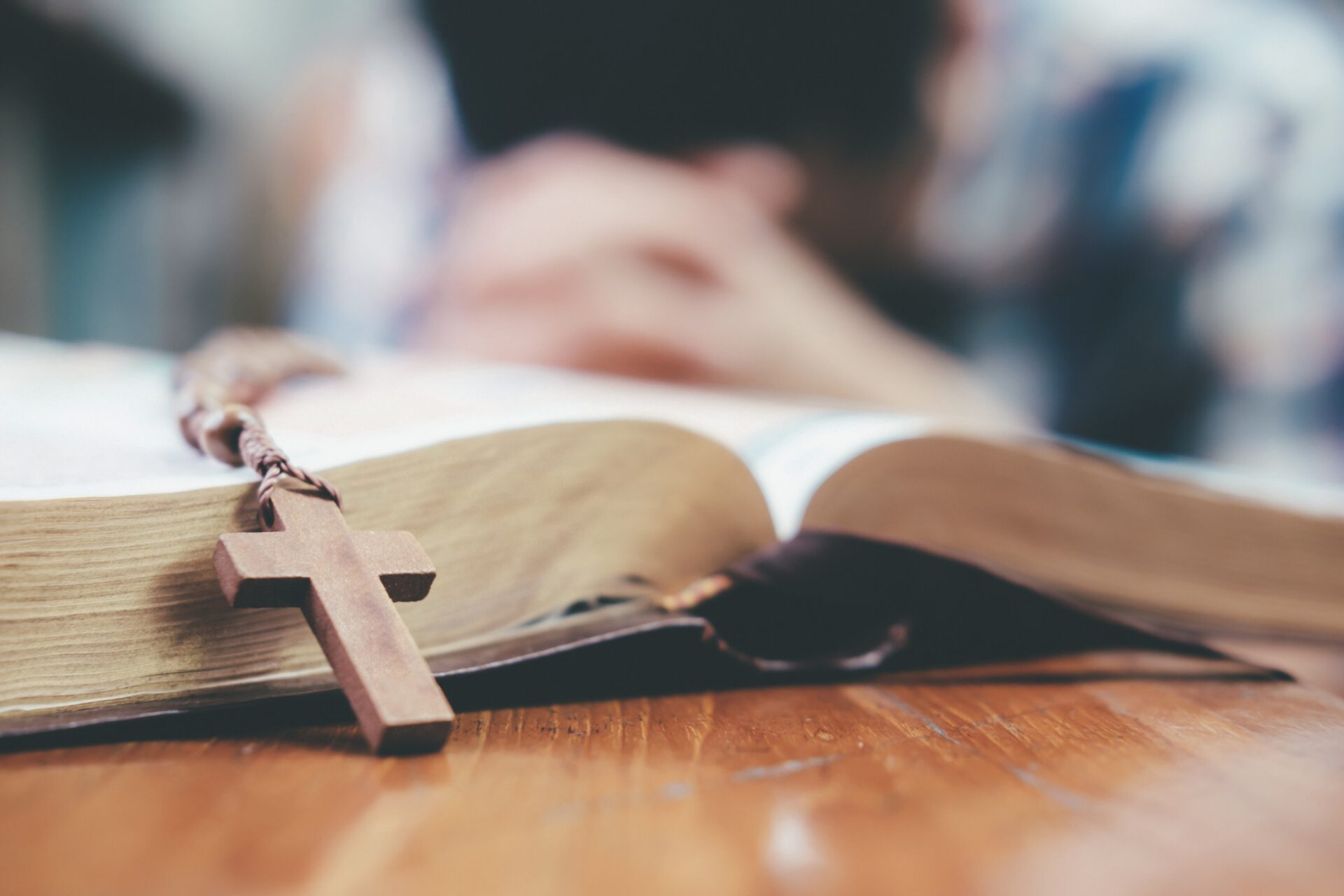 man praying hands clasped together on his bible 2022 08 01 03 18 48 utc