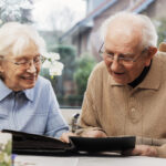senior couple watching old photographs at home 2022 03 08 01 04 05 utc