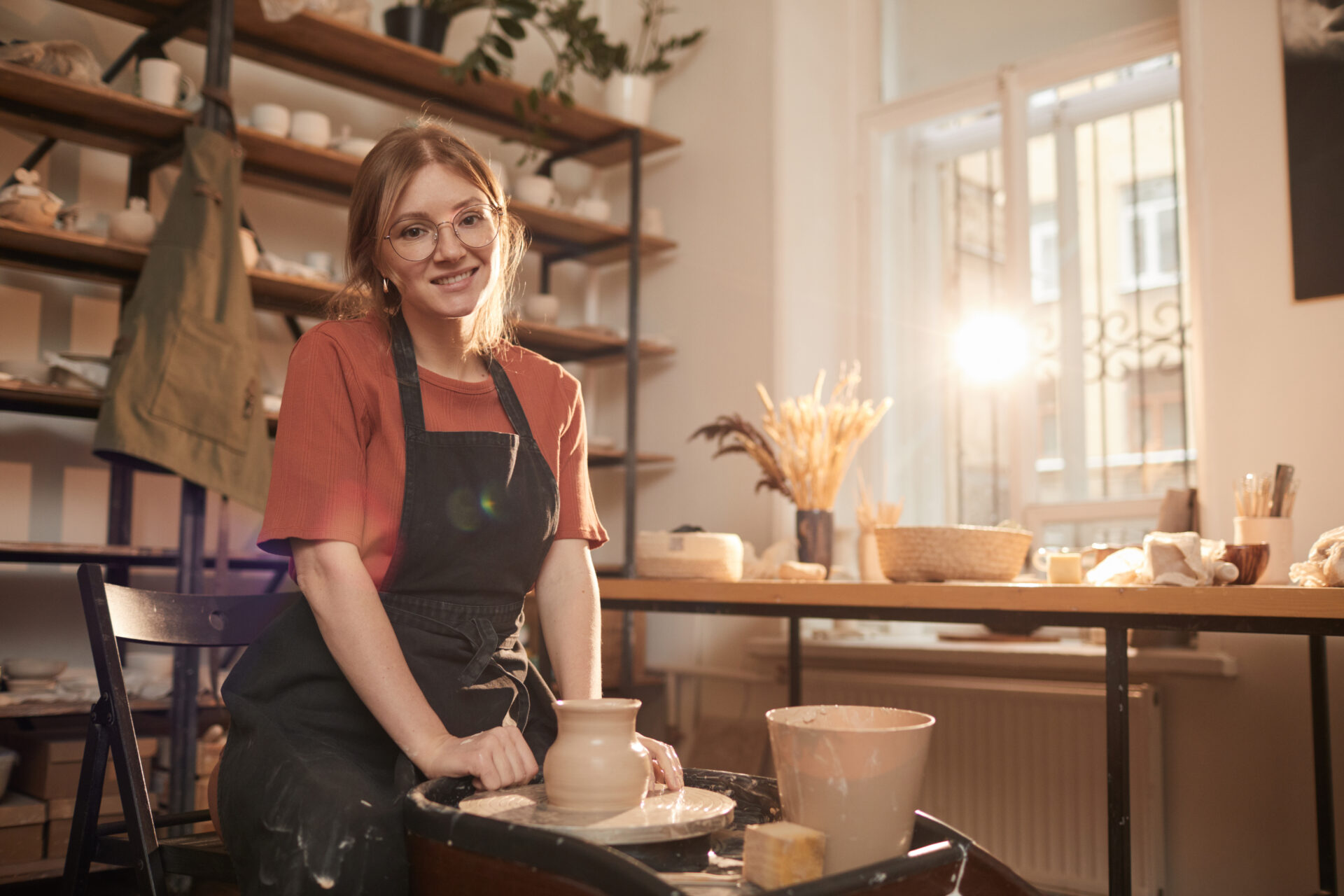 smiling female potter in sunlight 2021 09 24 04 13 22 utc