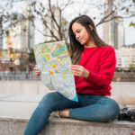 young latin woman with a map 2021 08 30 01 21 00 utc