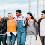 five young adult friends meeting hugging and laugh 2022 07 12 16 30 34 utc