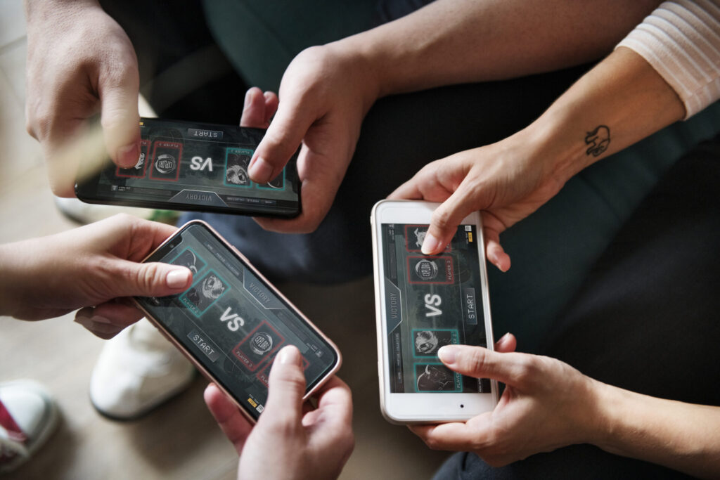 group of diverse friends playing game on mobile ph 2021 08 27 00 02 19 utc