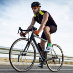 handsome young man cycling on the road 2022 02 02 04 51 02 utc