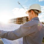 architect in helmet with blueprints looks at camer 2022 03 30 20 23 41 utc