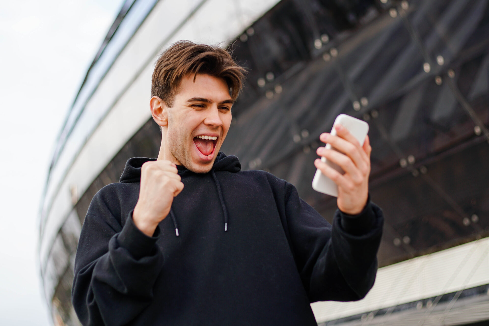 cheerful man holding smartphone and celebrate win 2022 09 28 22 52 54 utc