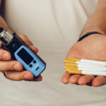 male holding cigarettes and vape inhaler close up 2021 09 03 14 39 22 utc
