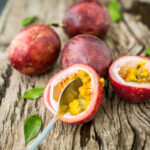 passion fruit on a wooden board with knife 2021 09 03 03 03 35 utc