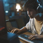 teenager wearing headphones and playing online vid 2022 01 19 00 21 34 utc
