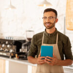 bearded businessman owning coffee shop holding tab 2022 02 03 07 02 22 utc