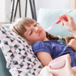 disgusted sick little girl eating medicine syrup 2021 08 30 08 39 28 utc