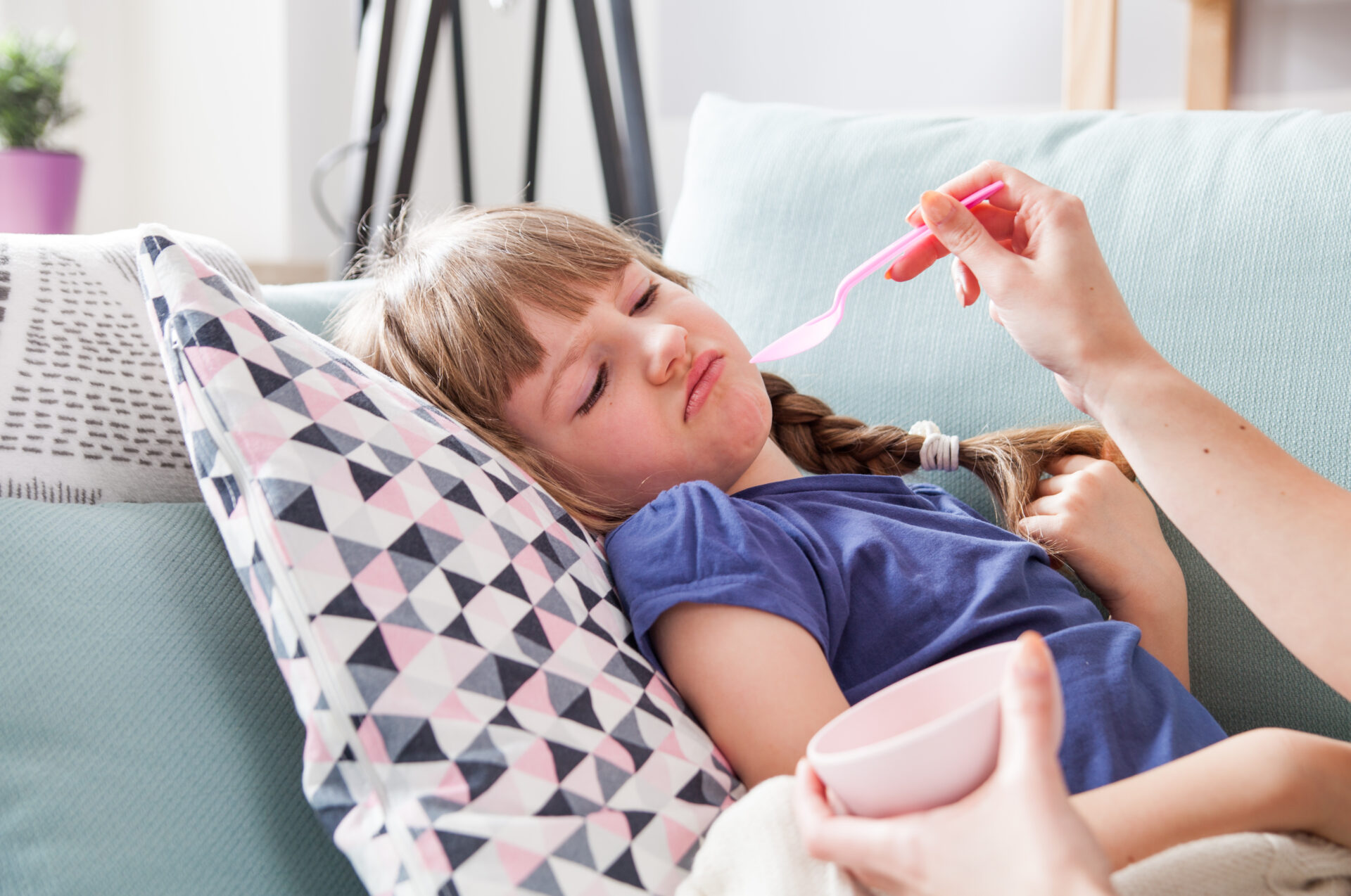 disgusted sick little girl eating medicine syrup 2021 08 30 08 39 28 utc