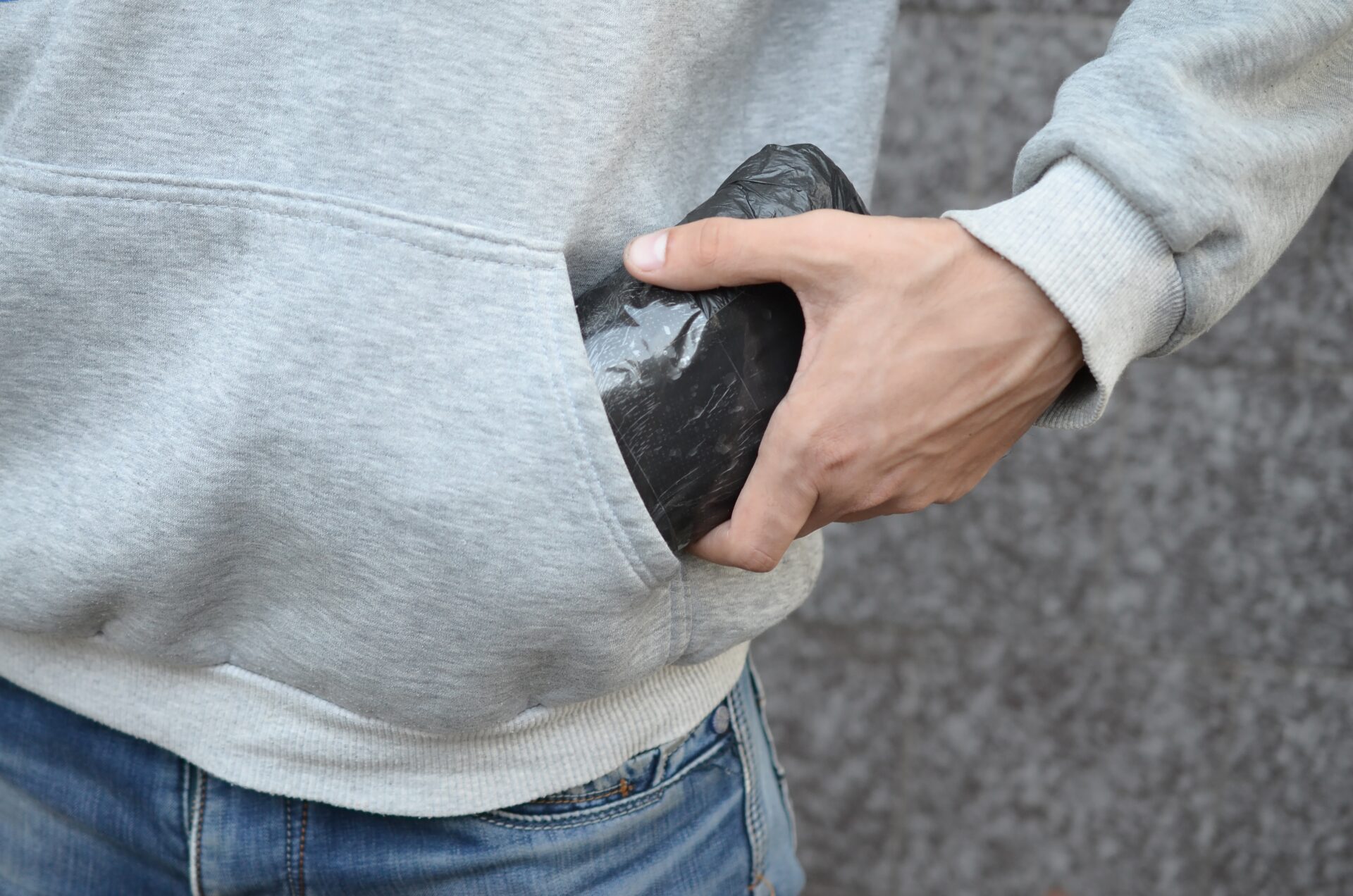 drug dealer taking bag with cocaine out of hoodie 2022 11 14 15 59 26 utc