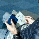 man with airplane tickets and passport 2022 11 01 04 34 42 utc
