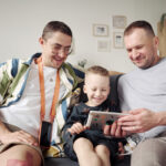 same sex couple with child using tablet pc at home 2022 07 07 23 55 30 utc