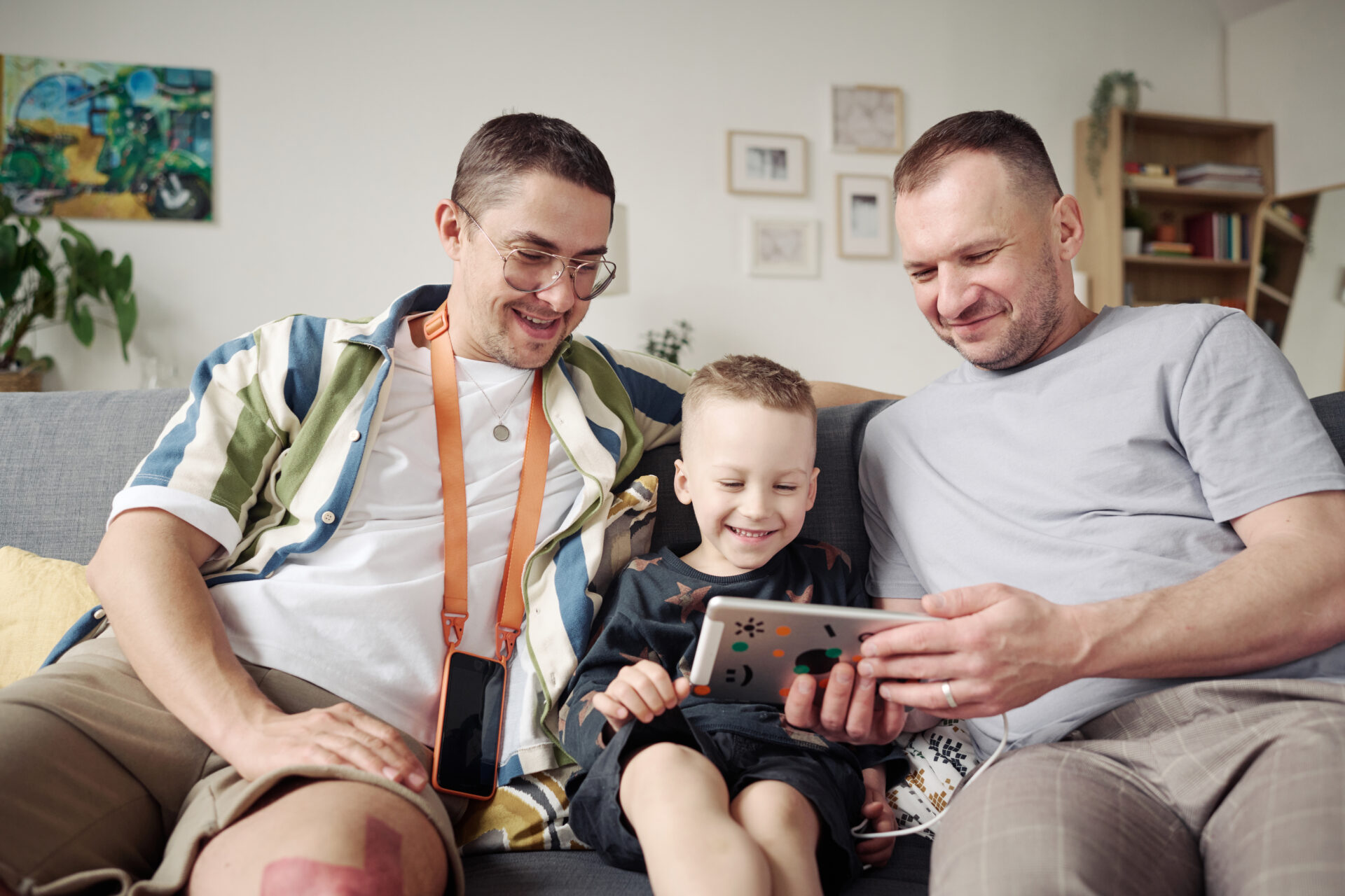 same sex couple with child using tablet pc at home 2022 07 07 23 55 30 utc