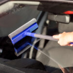 woman wiping a car windshield 2022 08 19 06 54 26 utc