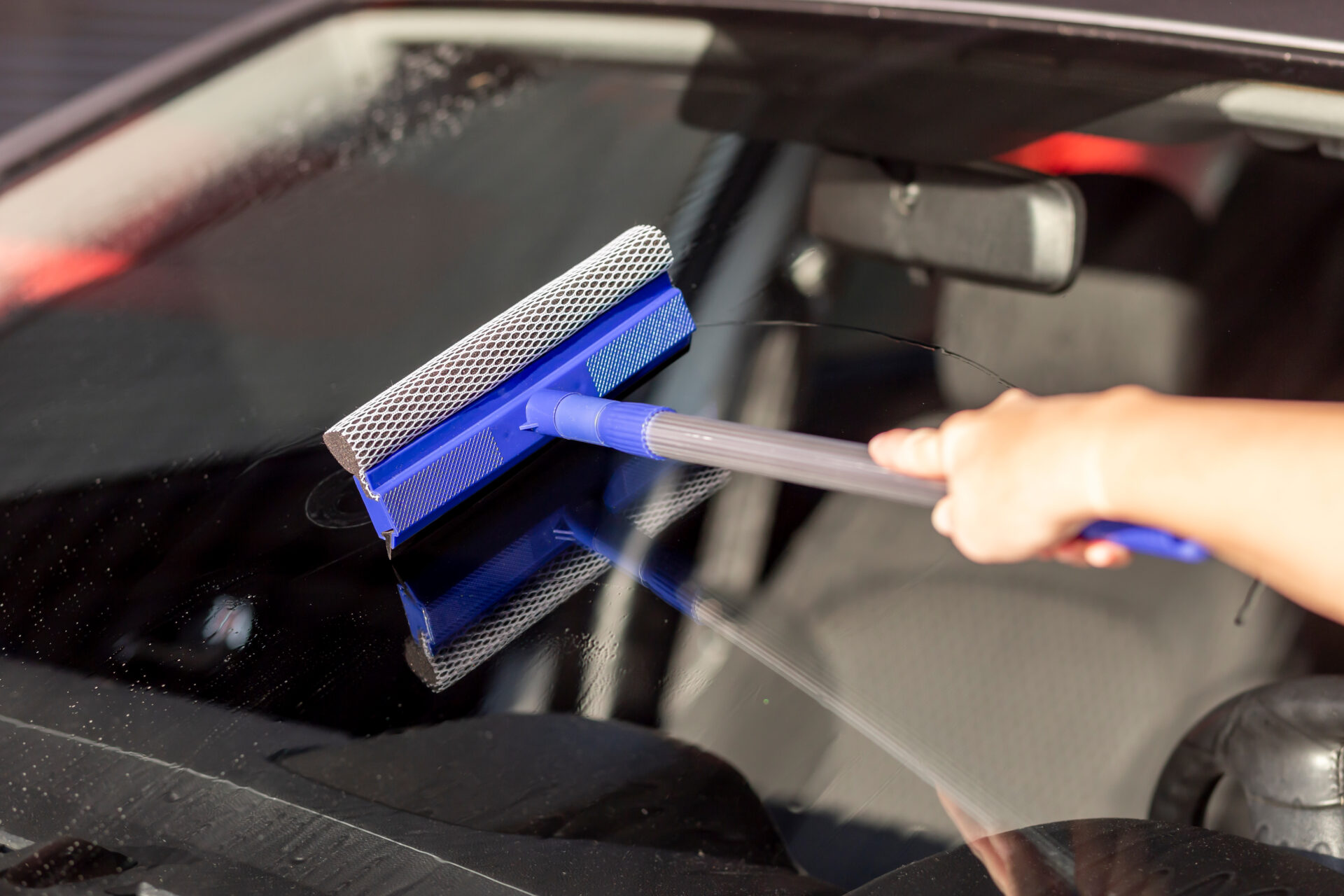 woman wiping a car windshield 2022 08 19 06 54 26 utc