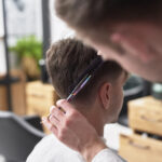 young man has cutting hair at the hairdresser 2021 08 27 09 09 44 utc