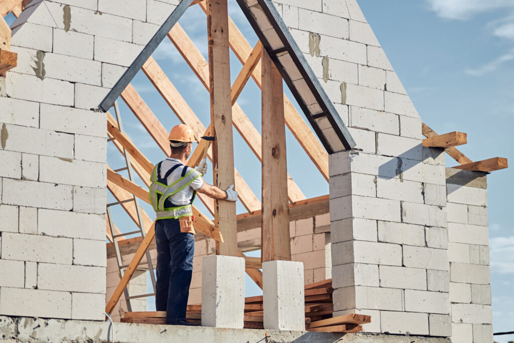 concentrated man in safety gear building a house 2021 09 03 21 02 56 utc