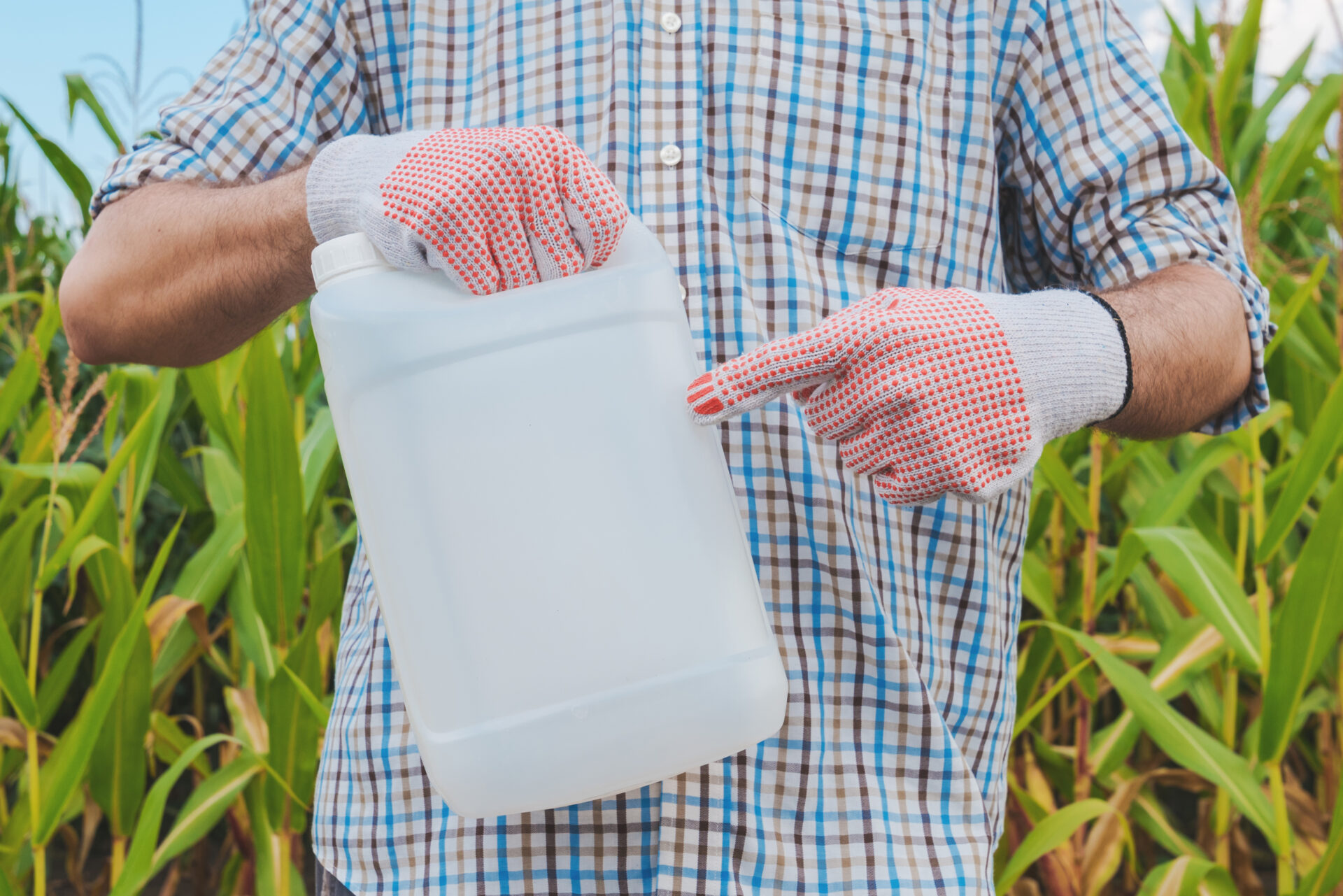 farmer holding pesticide chemical jug in cornfield 2021 08 26 23 03 08 utc