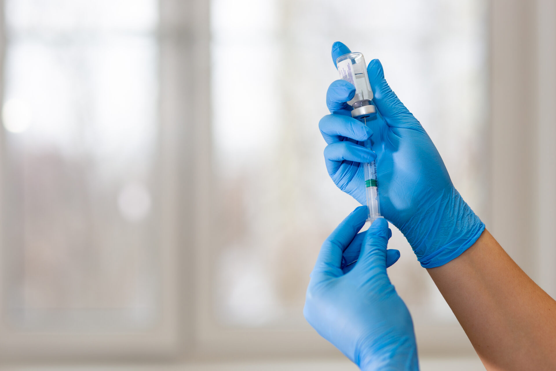 hands of a doctor or nurse in blue gloves with a m 2023 02 17 18 40 34 utc