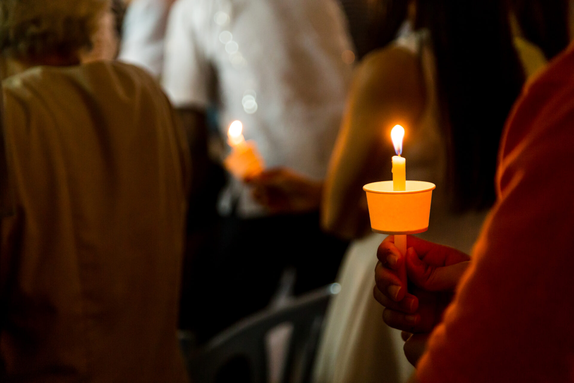 closeup of people holding candle vigil in dark see 2021 09 01 23 16 39 utc