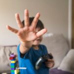 kid showing stop gestures with his hand while hold 2022 11 15 14 05 53 utc