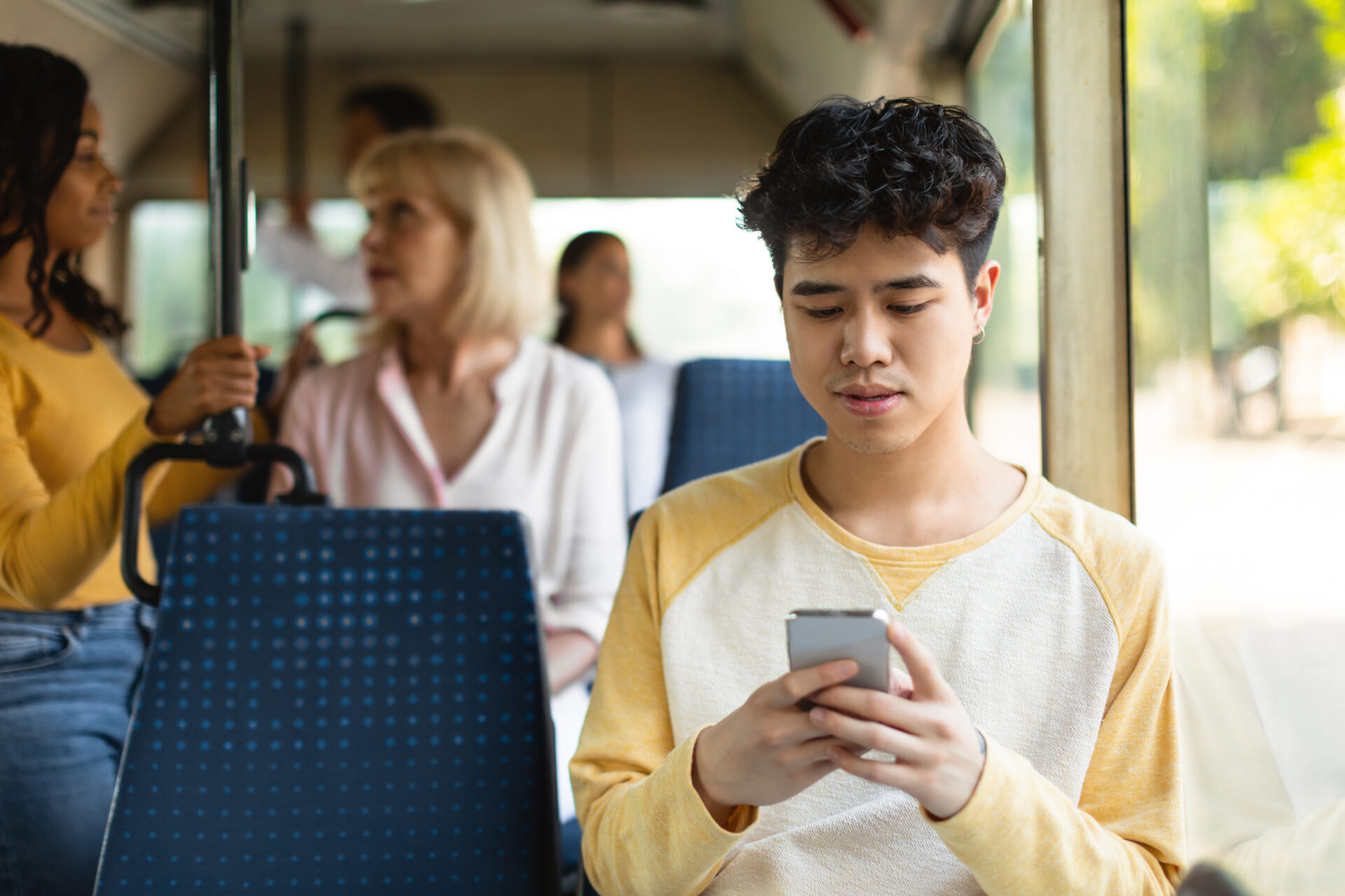 portrait of asian guy using cellphone in bus 2022 12 16 07 50 41 utc