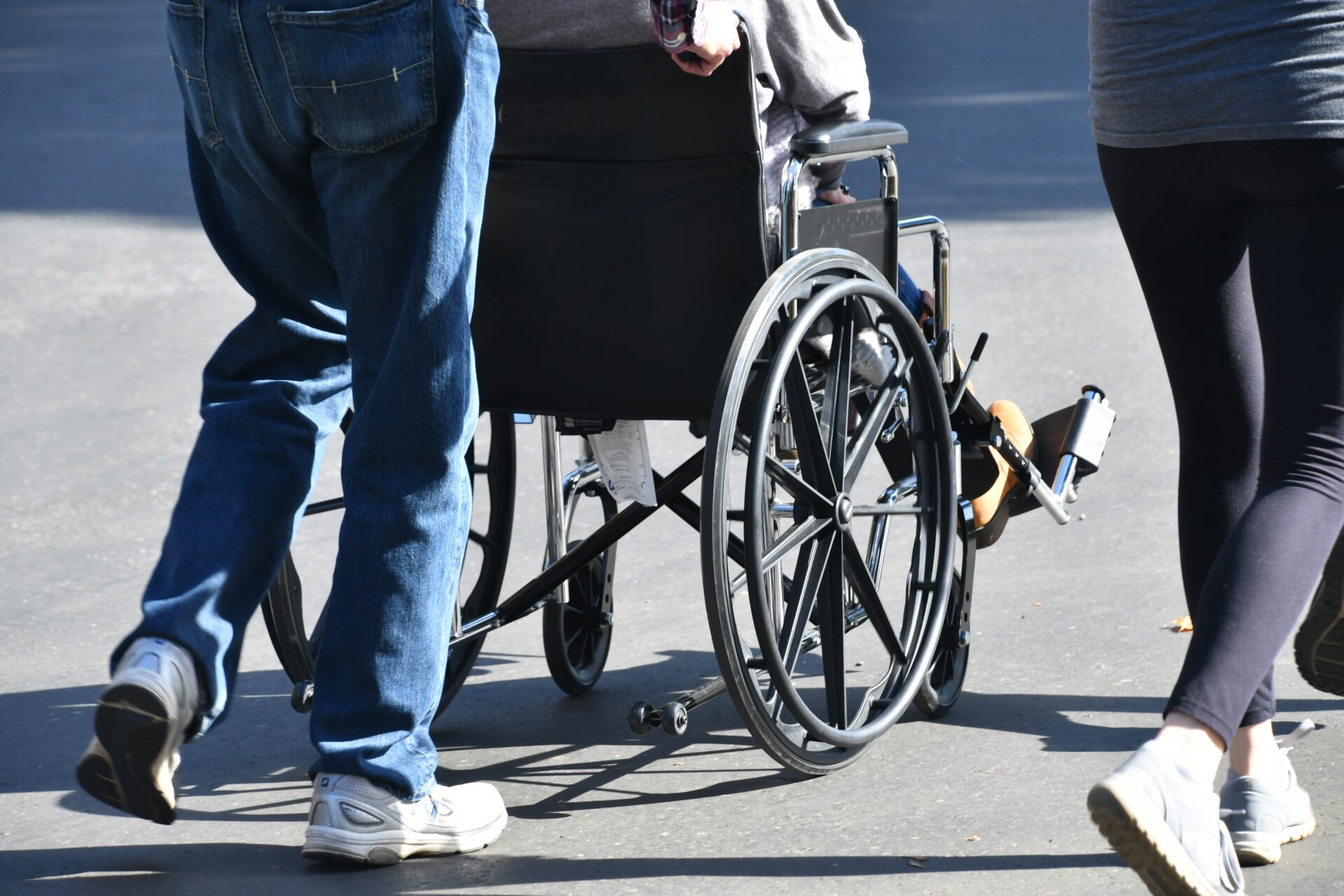 man pushing a female in a wheelchair across paveme 2022 11 14 03 46 06 utc