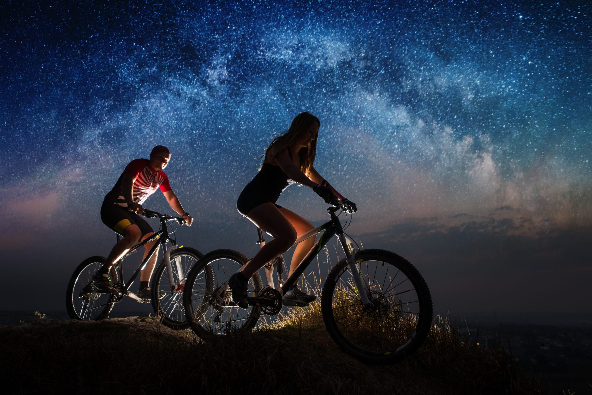 sporty couple riding a bicycles at night under sta 2022 05 10 23 50 33 utc
