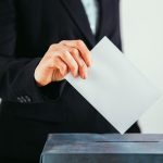 close up of voter putting ballot into voting box 2022 01 10 20 22 35 utc