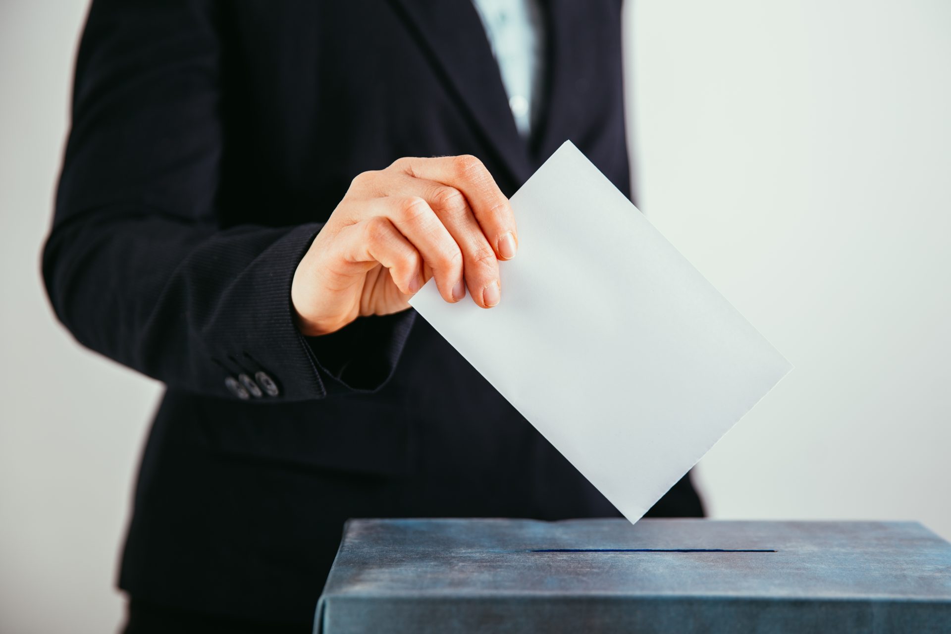 close up of voter putting ballot into voting box 2022 01 10 20 22 35 utc
