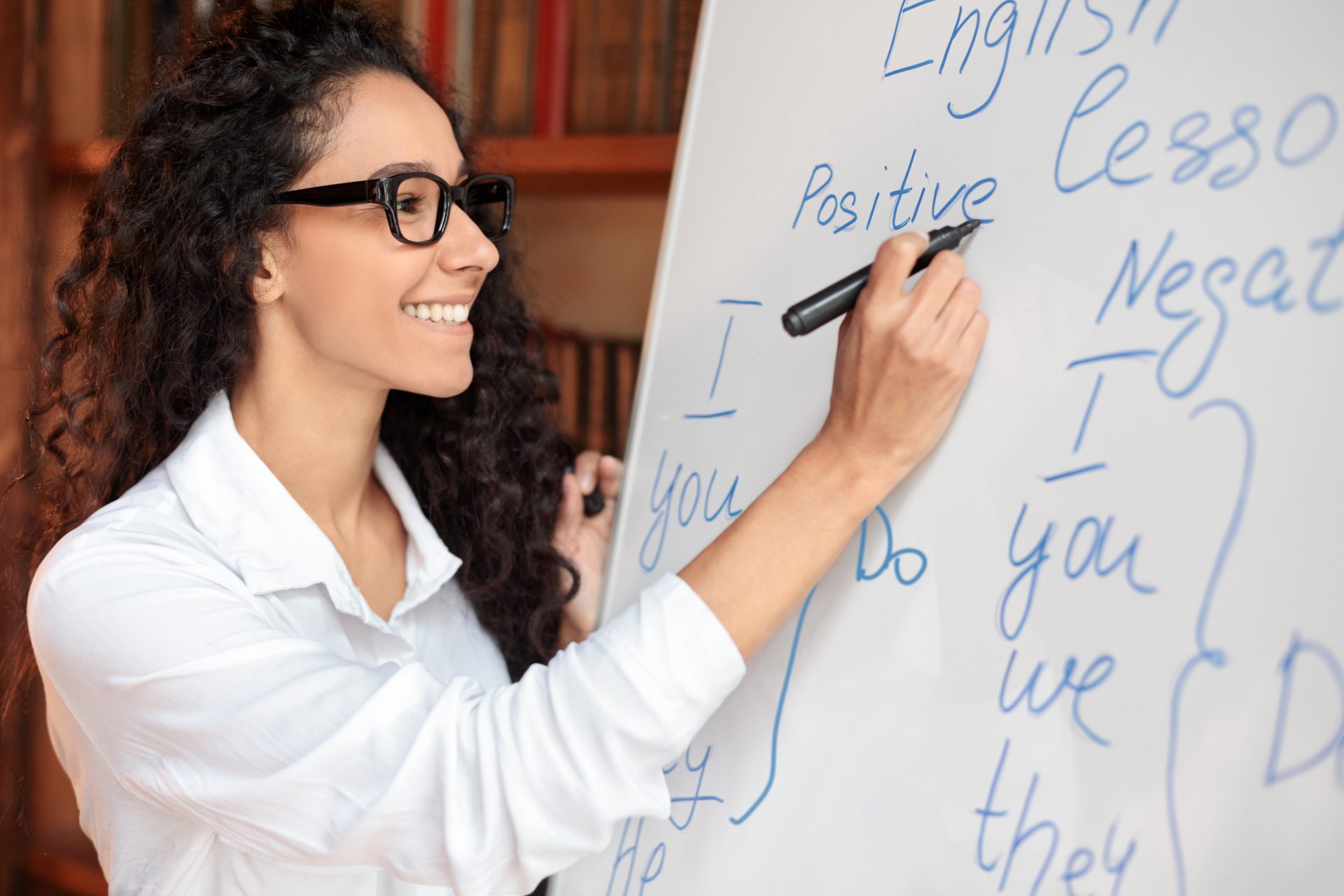 english teacher standing at whiteboard writing ru 2022 12 16 07 59 38 utc