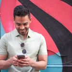 cheerful young latin guy texting chatting on his 2022 11 07 22 50 13 utc