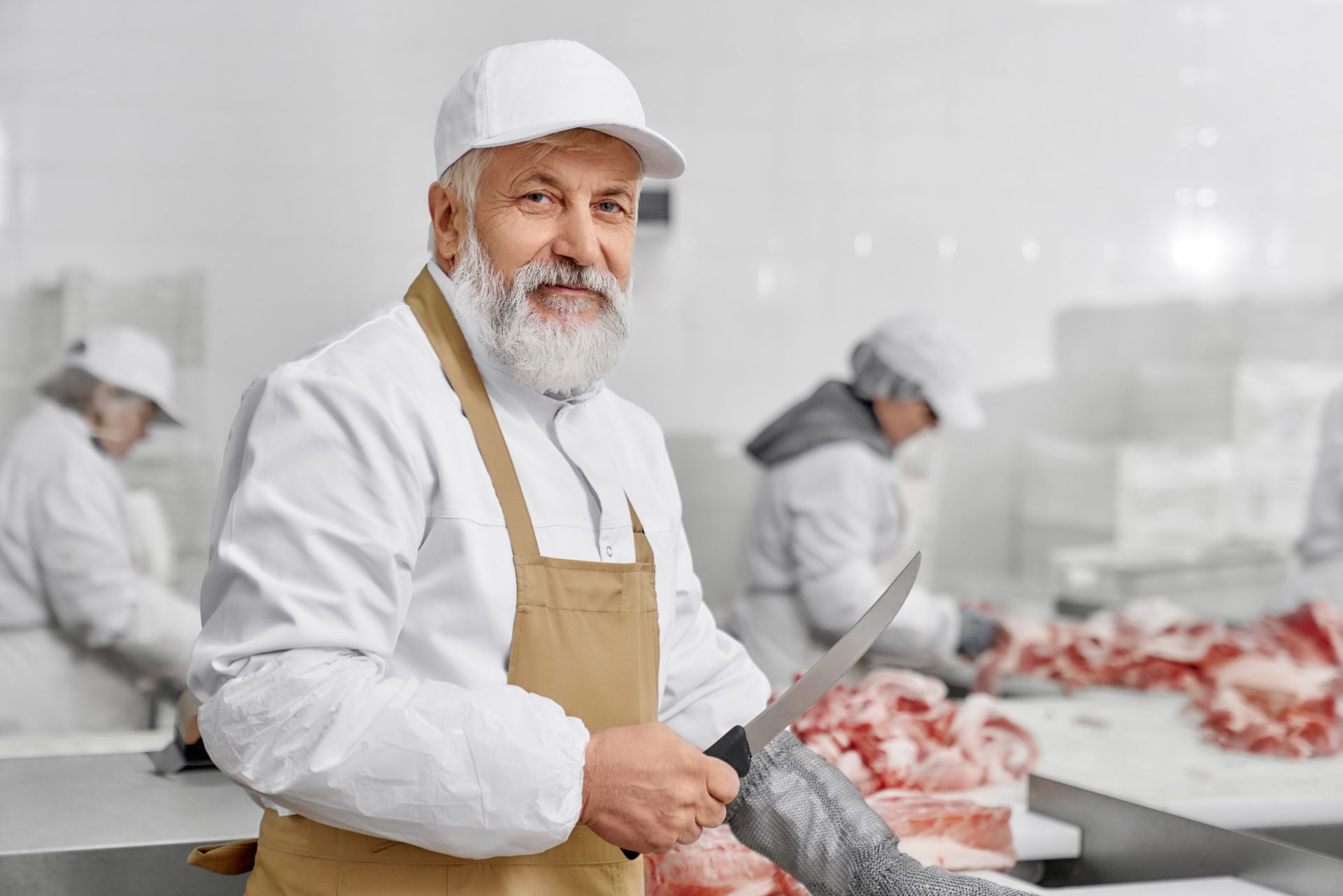 elderly man working on butchery cutting meat with 2021 08 29 23 21 10 utc