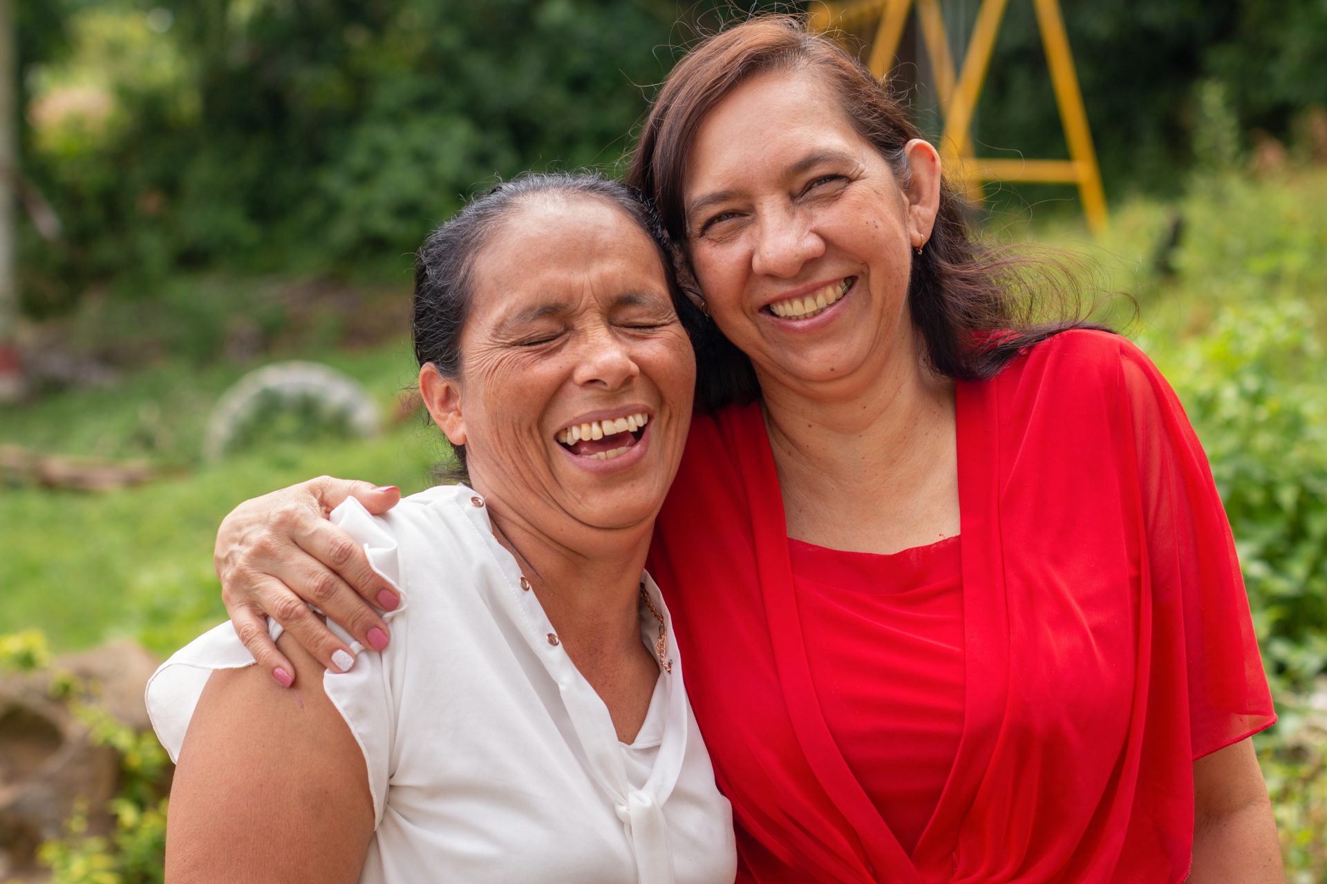 portrait of two older latin women hugging and laug 2022 07 08 17 26 00 utc