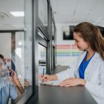 young doctor talking at hospital reception with he 2022 11 16 20 04 24 utc