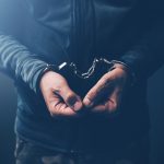 arrested computer hacker with handcuffs 2021 08 26 23 02 58 utc