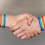close up of a handshake with wristbands supporting 2023 06 28 01 31 43 utc