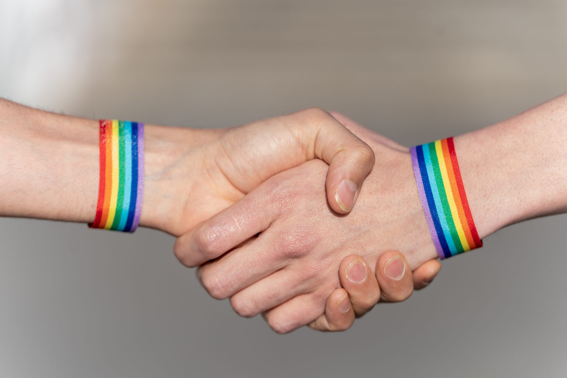 close up of a handshake with wristbands supporting 2023 06 28 01 31 43 utc