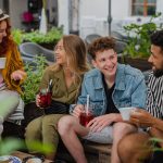 group of happy young people sitting in outdoors ca 2022 01 18 23 39 04 utc