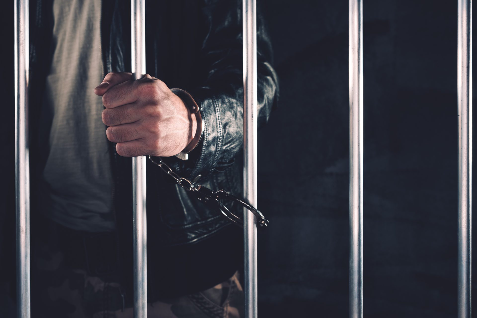 handcuffed man behind prison bars 2021 08 26 23 02 50 utc