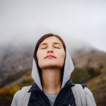 asian woman stands by the mountain cold weather 2022 10 01 03 34 03 utc