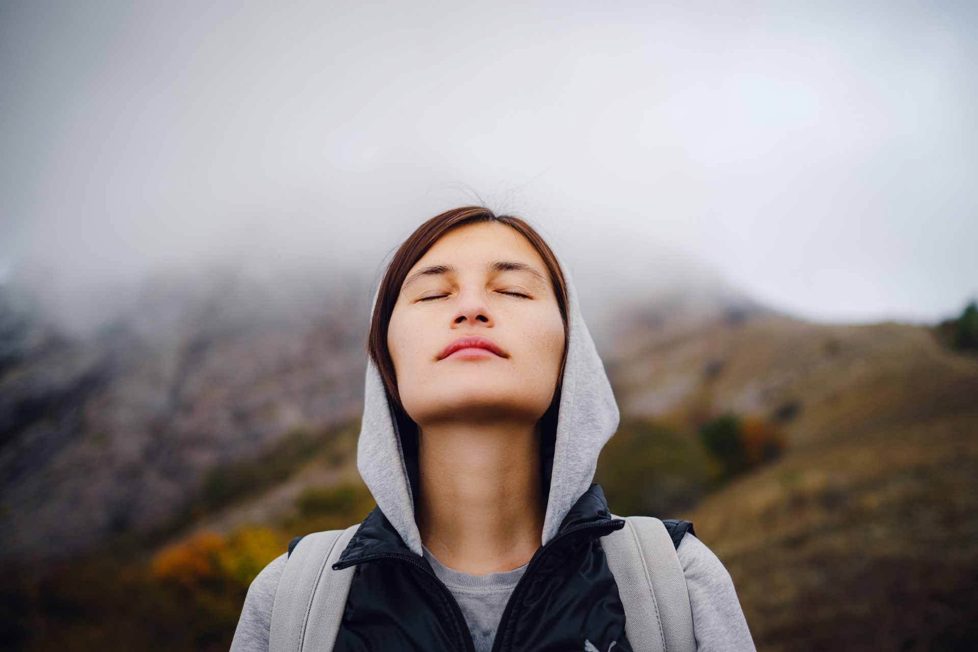 asian woman stands by the mountain cold weather 2022 10 01 03 34 03 utc
