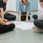 group of teenagers sit in a circle on the floor an 2021 08 29 06 08 57 utc