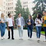 happy students walking outside the university buil 2022 12 16 07 04 42 utc