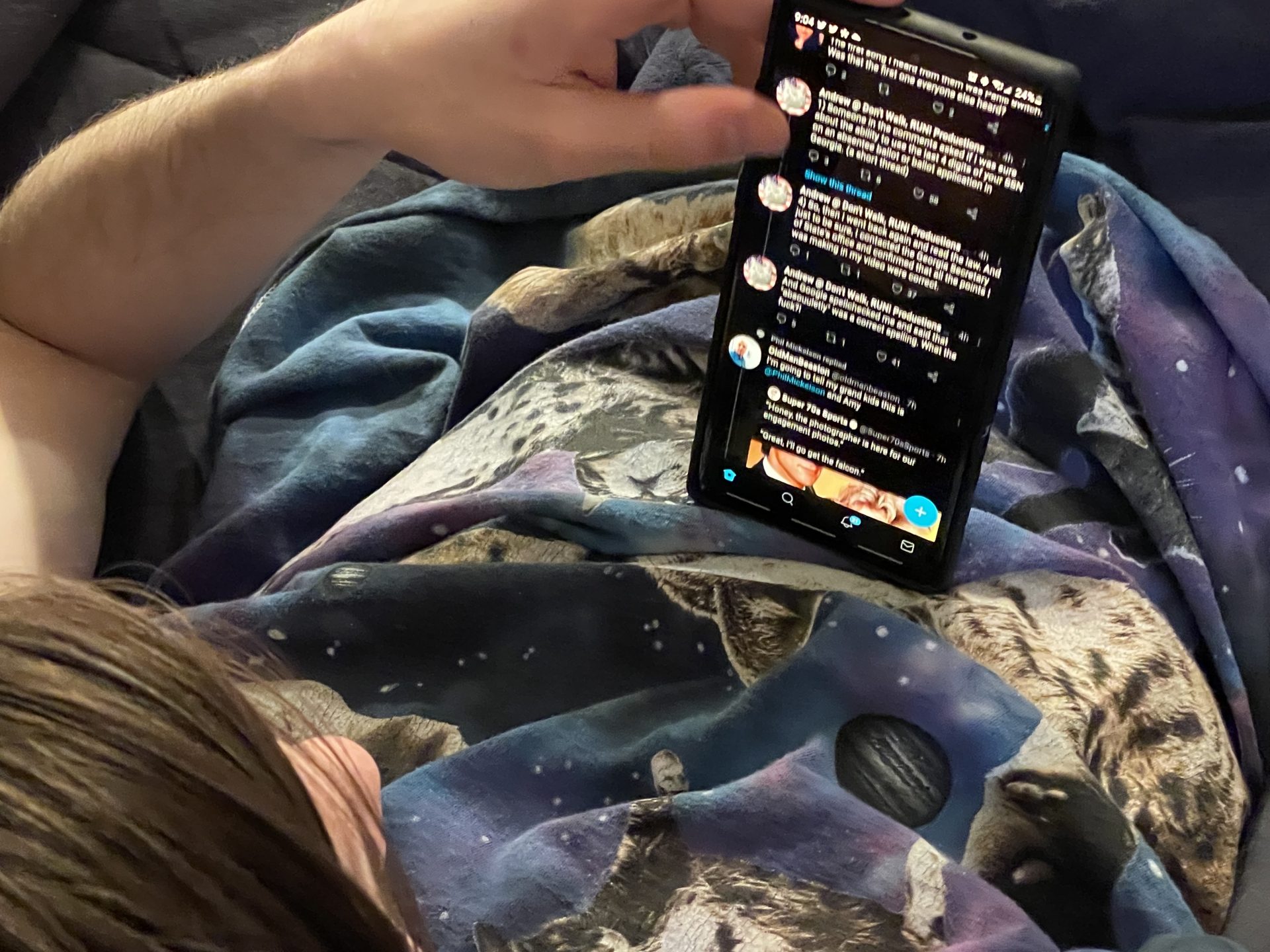 millennial in recliner balancing phone on stomach 2022 11 07 07 35 45 utc