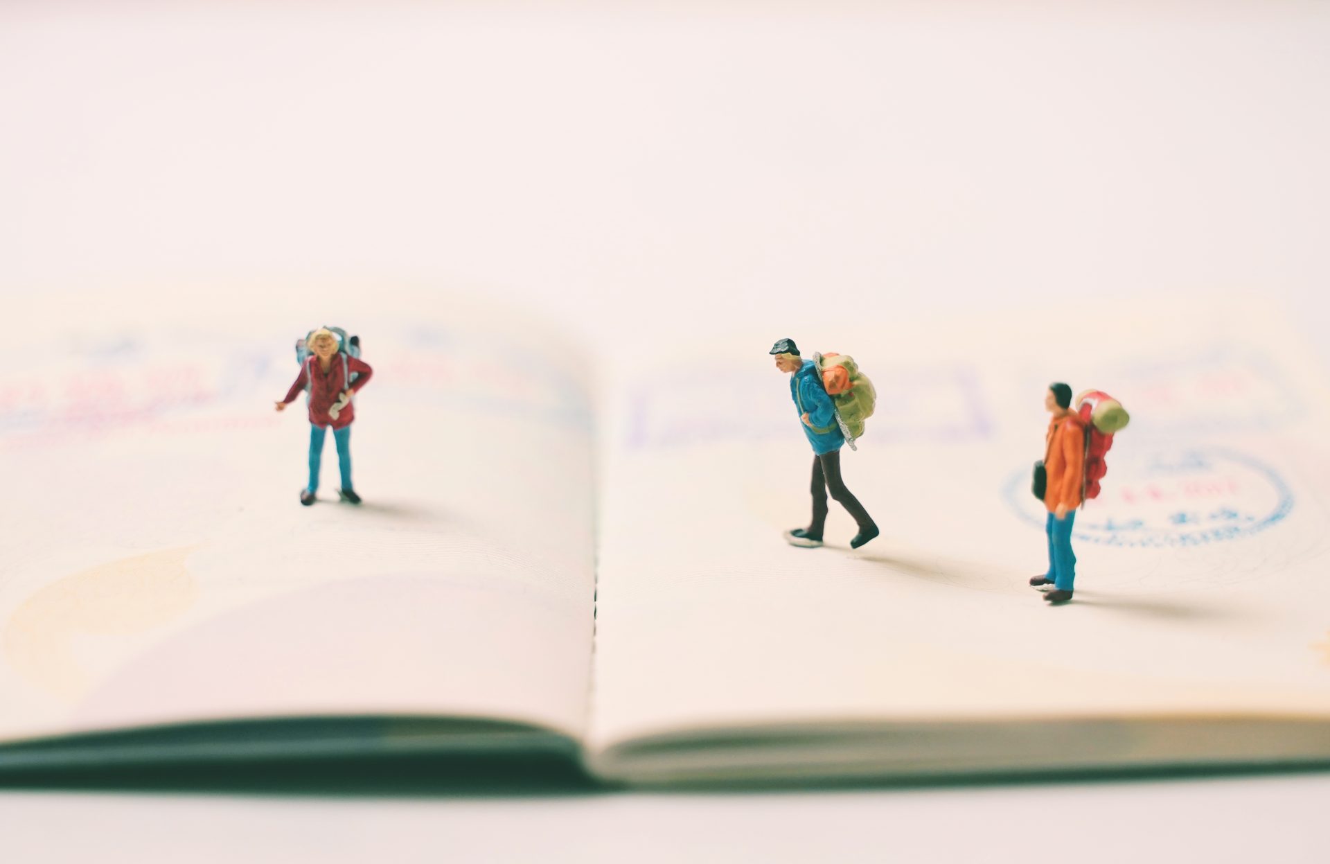miniature people backpack on passport page with im 2022 11 01 02 39 11 utc