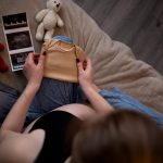 pregnant woman sits on the bed in the bedroom and 2023 09 12 16 56 18 utc